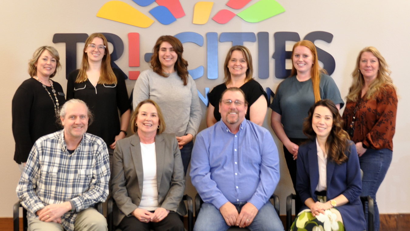 A group of employees smile for a group photo