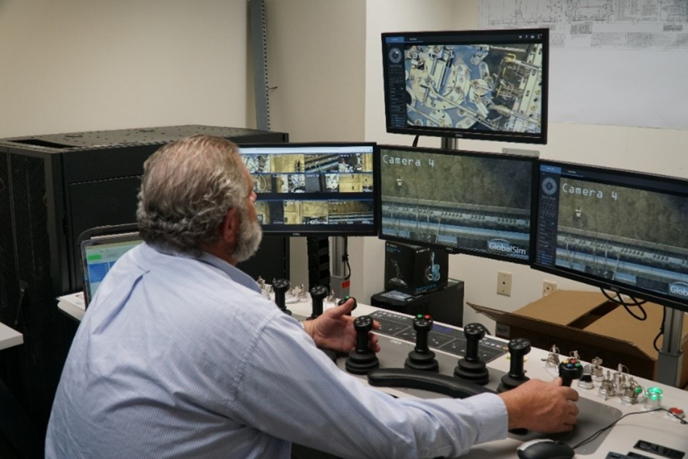An employee sitting at a crane simulator set up