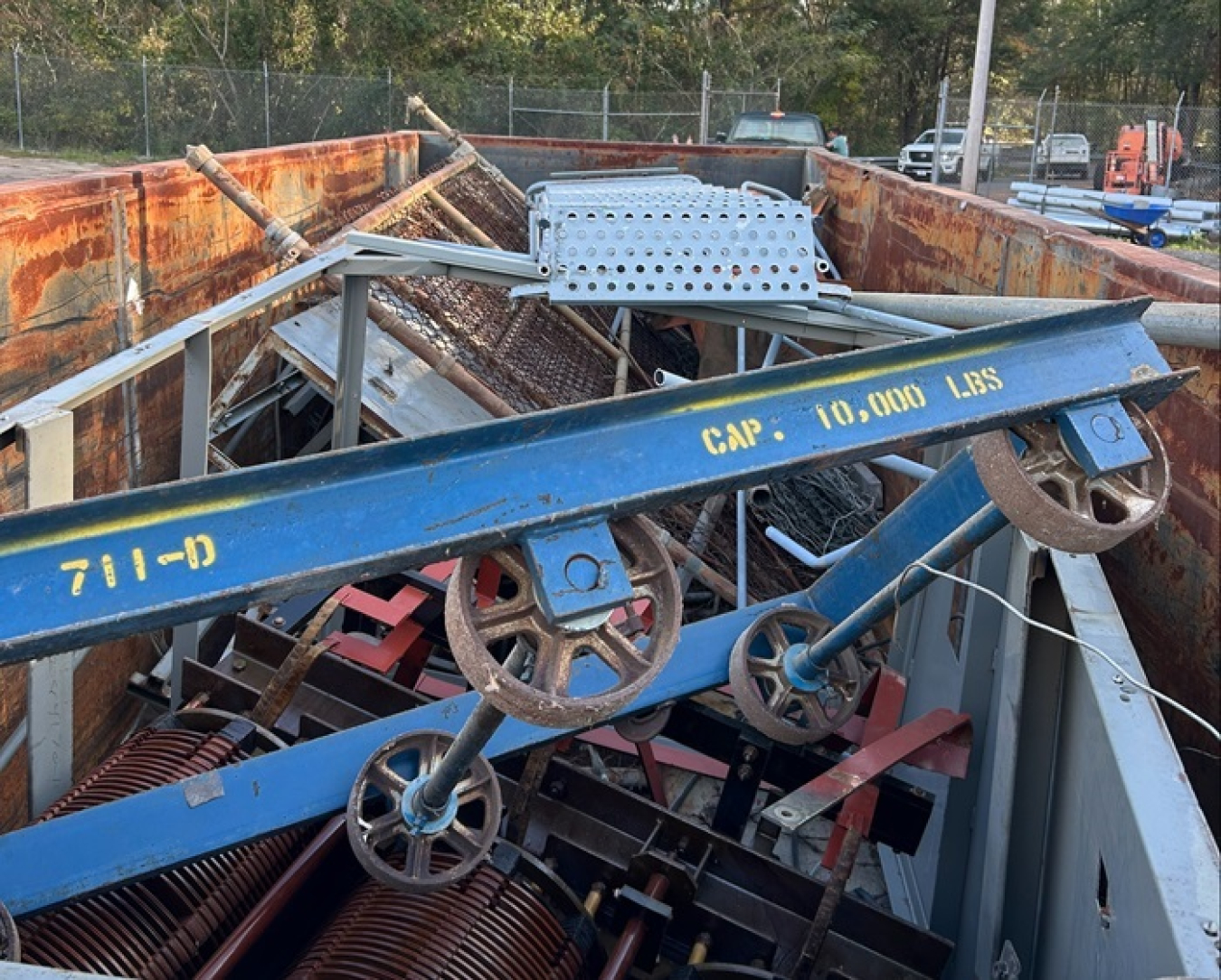 A pile of blue, white, red, and black scrap metal 