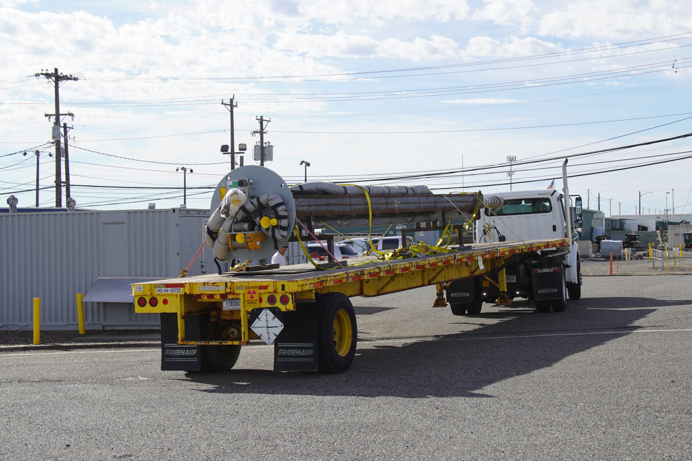 A pump being hauled on the back of a truck