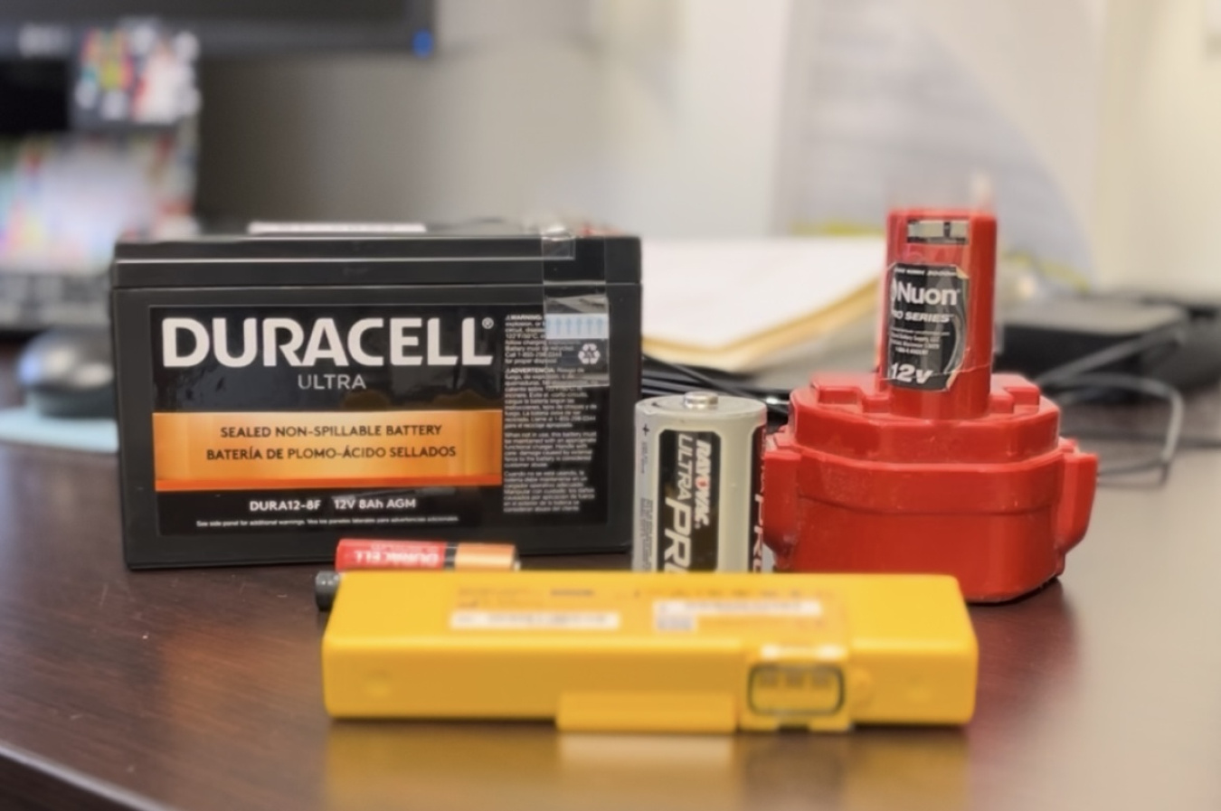 Three different types of batteries sitting on a table
