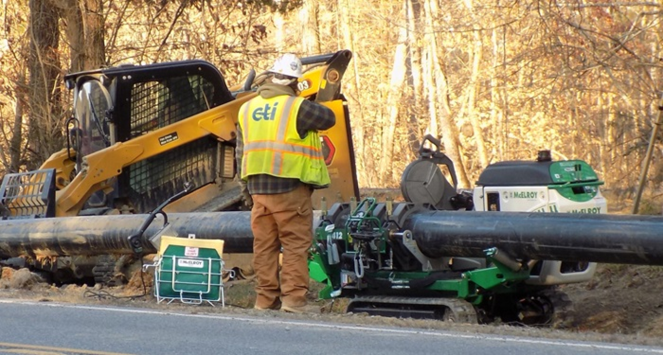 A worker installs waterline to the Environmental Management Disposal Facility site. 