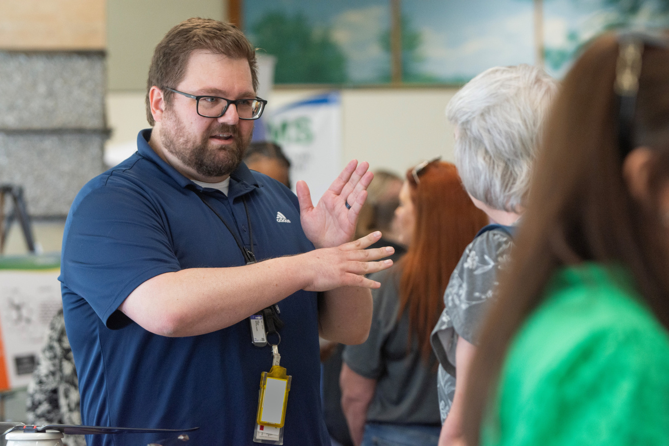 A man in a blue shirt having a conversation 