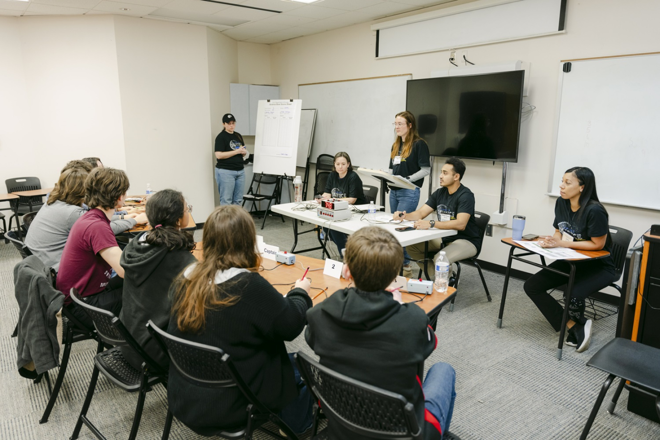 A group of students in a classroom competing in a science bowl