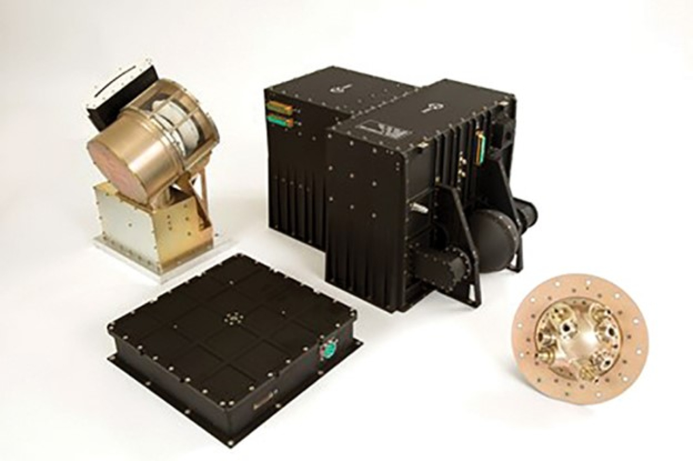 A photo of four objects, two black metal and two copper. One of the copper pieces is round with lots of little holes in it, another is cylinder-shaped, and the two black objects are box like.