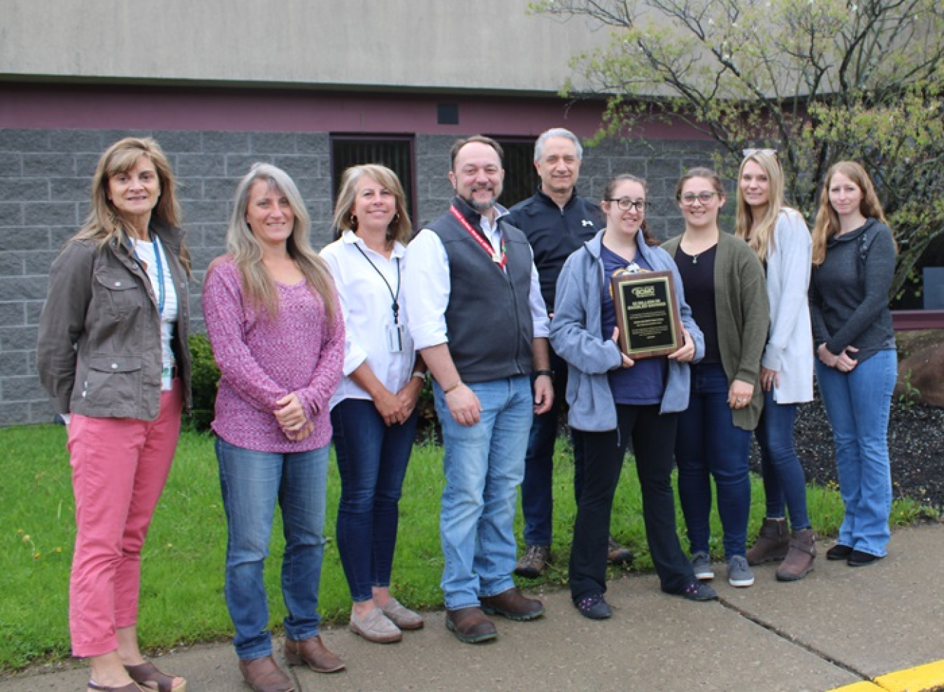 CH2M HILL BWXT West Valley (CHBWV) team holds a plaque commending the company for contributing $8.3 million toward a milestone $2 billion in savings by the U.S. Department of Energy’s Supply Chain Management Center. 