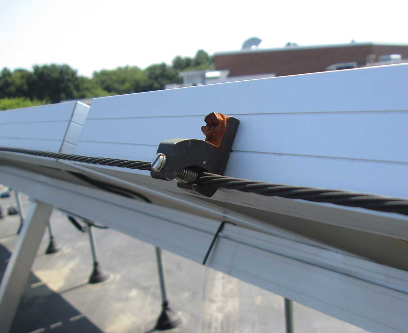 A corroded ground screen in a steel solar PV frame