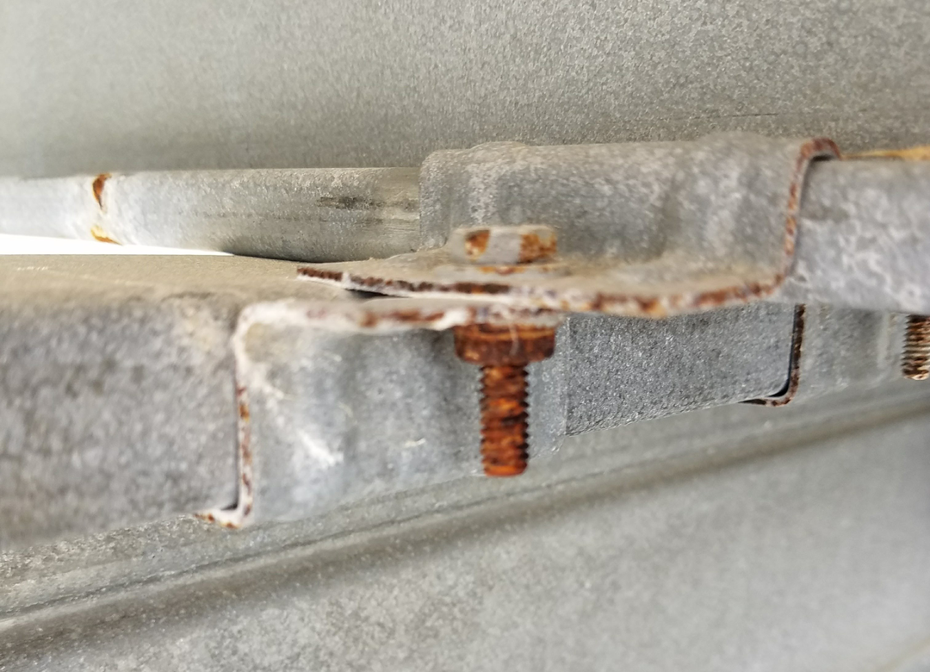 Bolt in steel frame that has oxidation corrosion