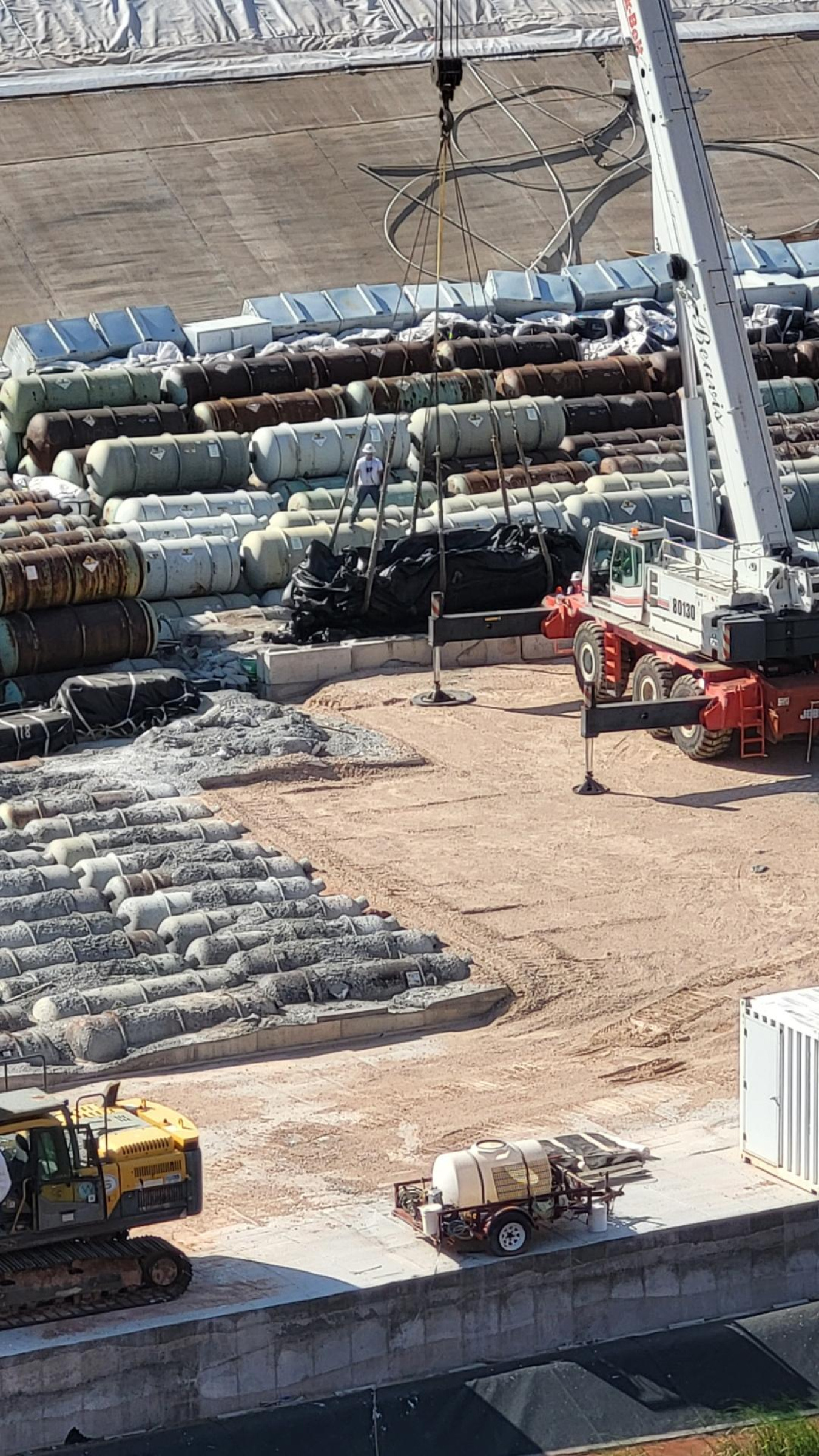 An overhead view of a large collection of tanks outside a building