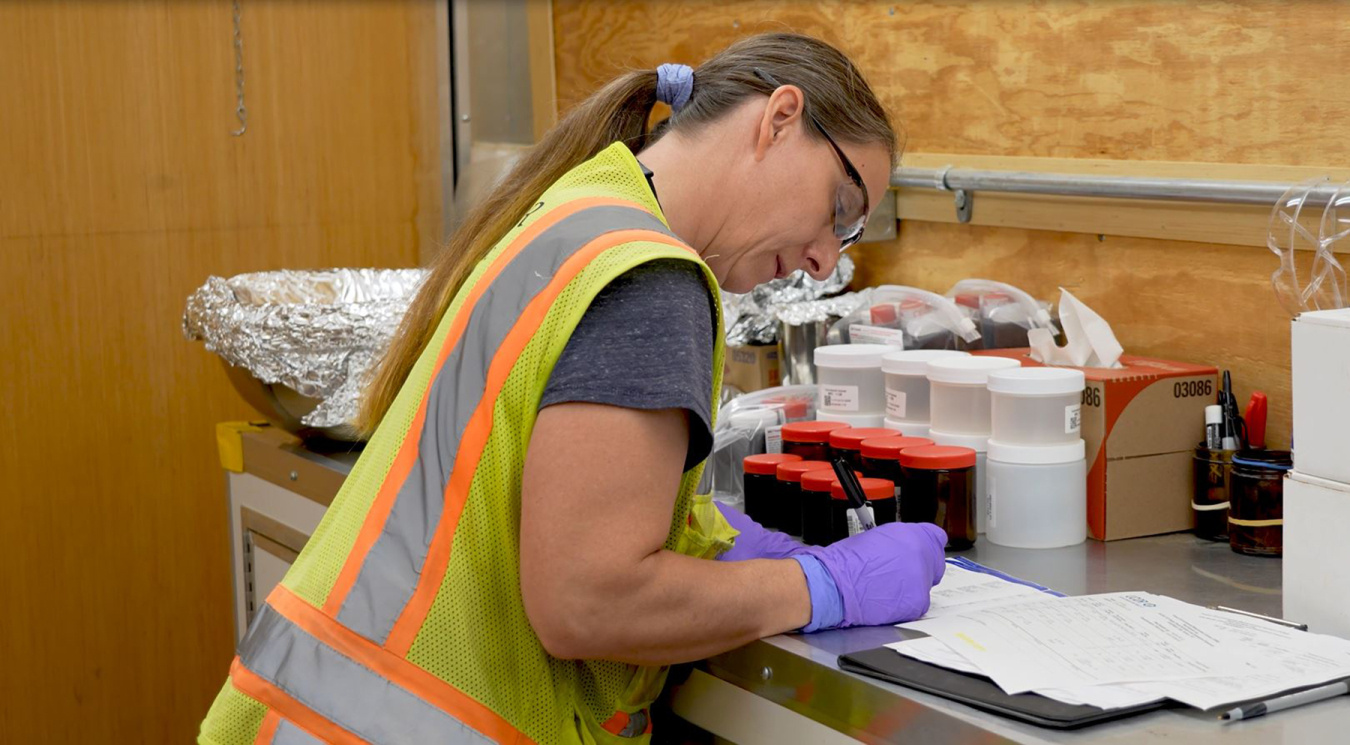 A woman in a laboratory taking samples of data