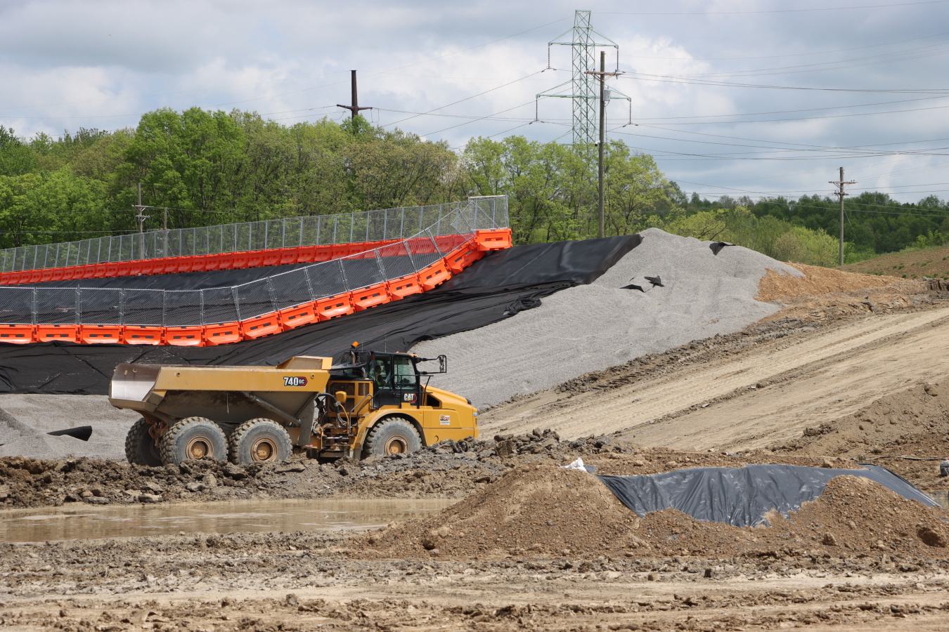 A construction vehicle moving materials via a truck ramp
