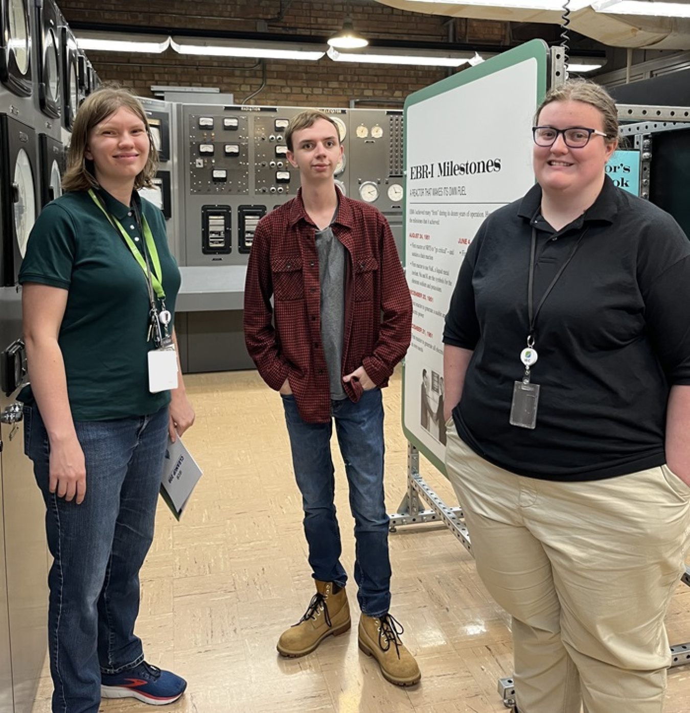 Three interns smiling for a group photo inside a laboratory 