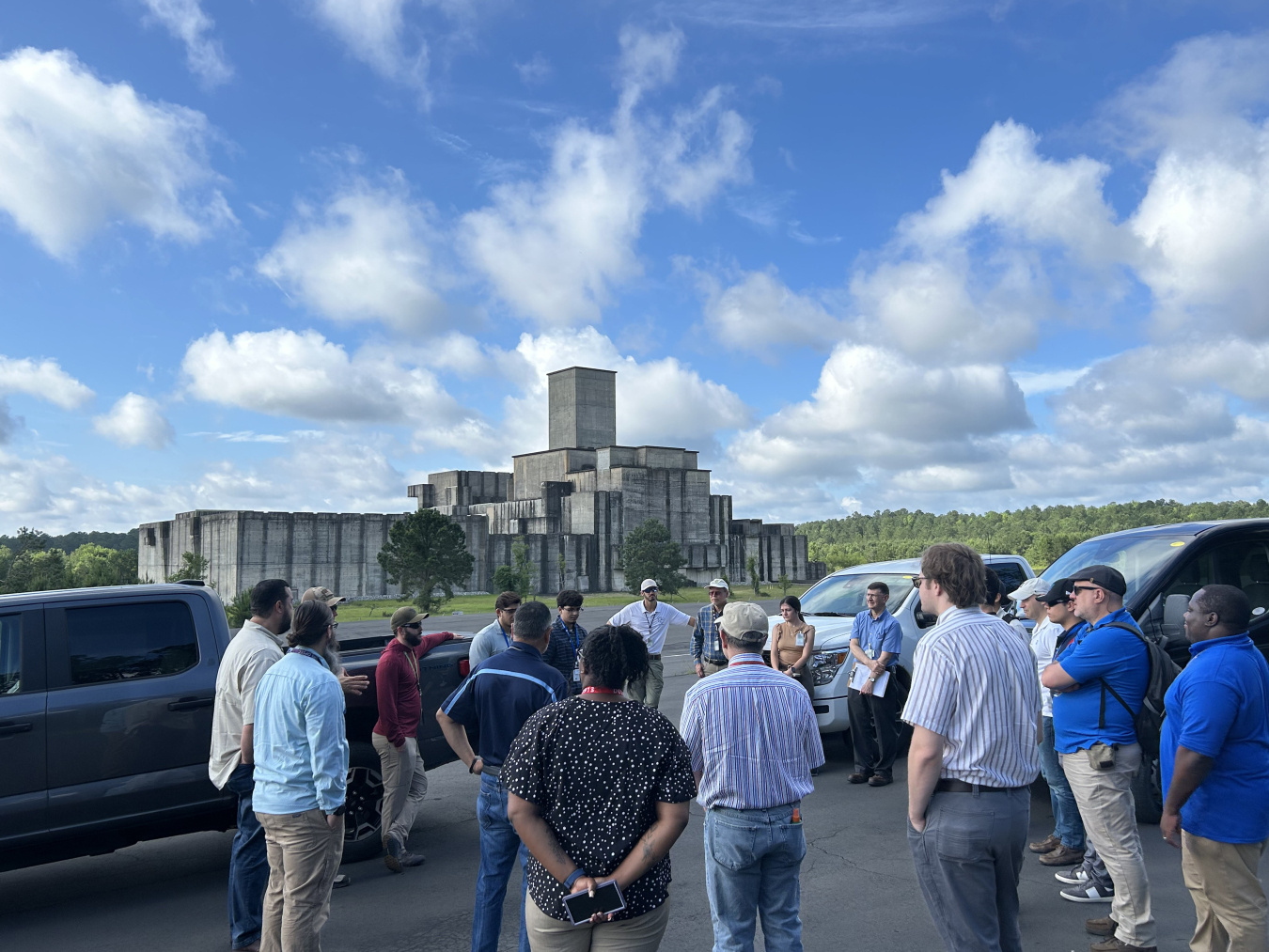 A group of people taking a tour of a basin outdoors