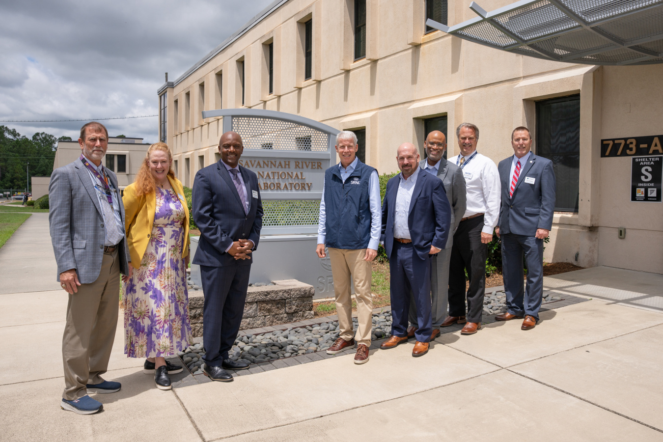 A group of individuals pose for a group picture outside of Savannah River National Laboratory