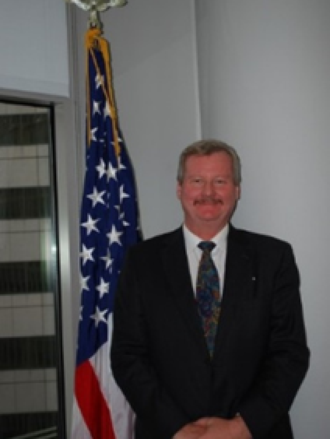 Professional headshot of a man in a suit