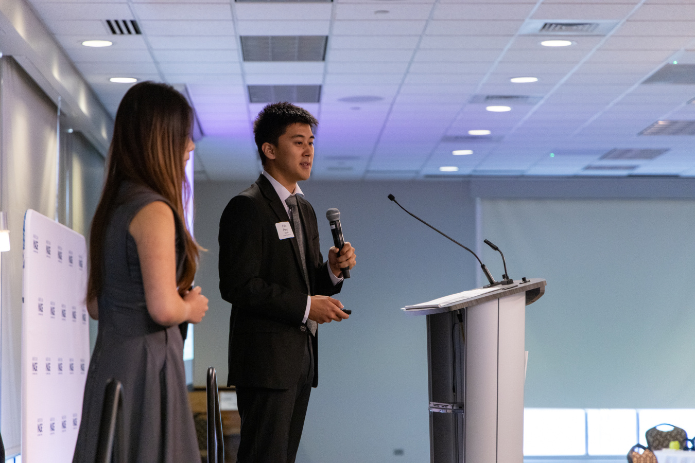 Two collegiate students pitching on stage at the 2025 EnergyTech UP national competition