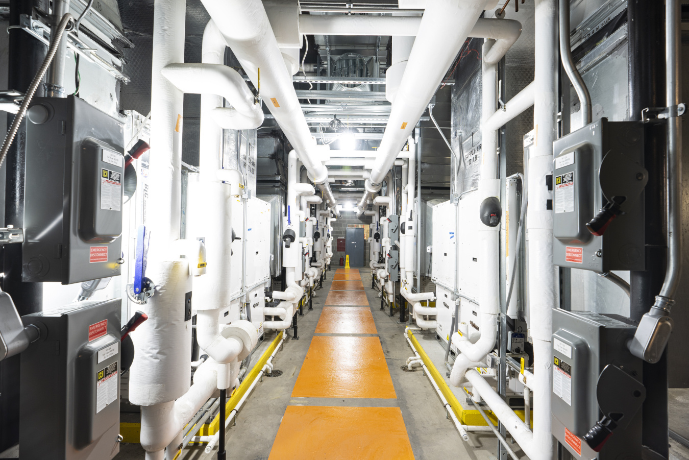 "Heat pump alley" located in the airport main central utility plant. All units shown have waterside economizers and are "twinned" to increase both system efficiency and resilience.