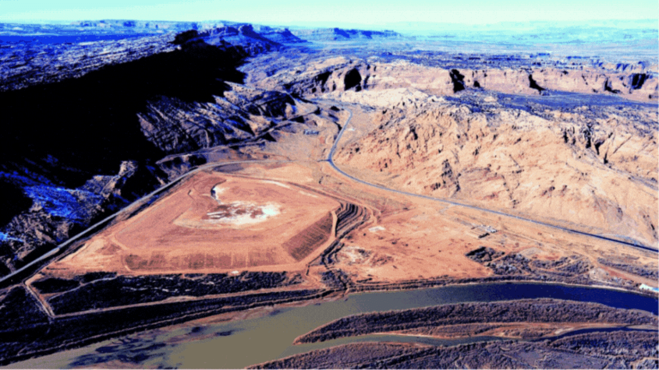 Two aerial images of the removal of the mill tail piles
