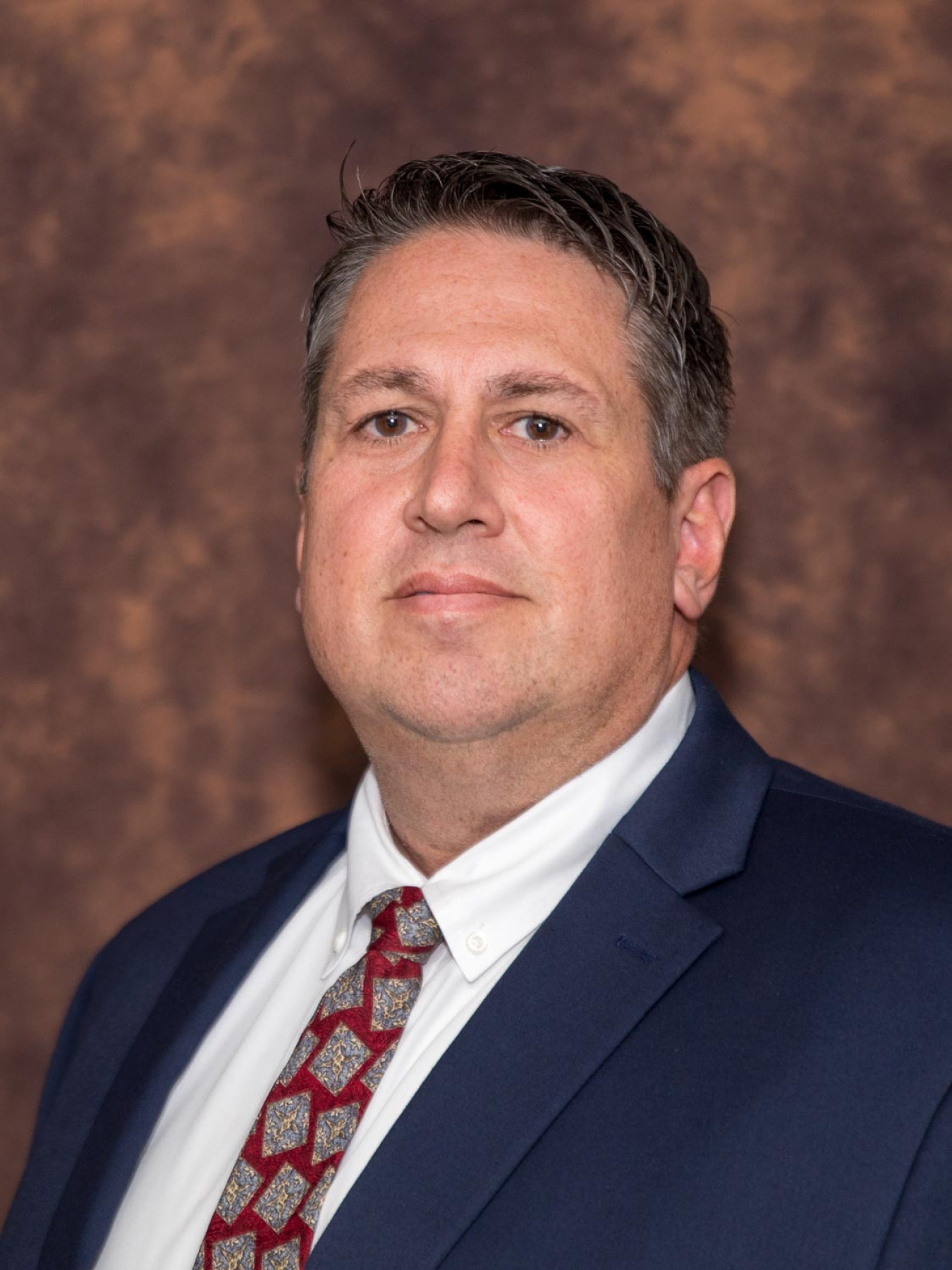 Professional headshot of a man in a suit