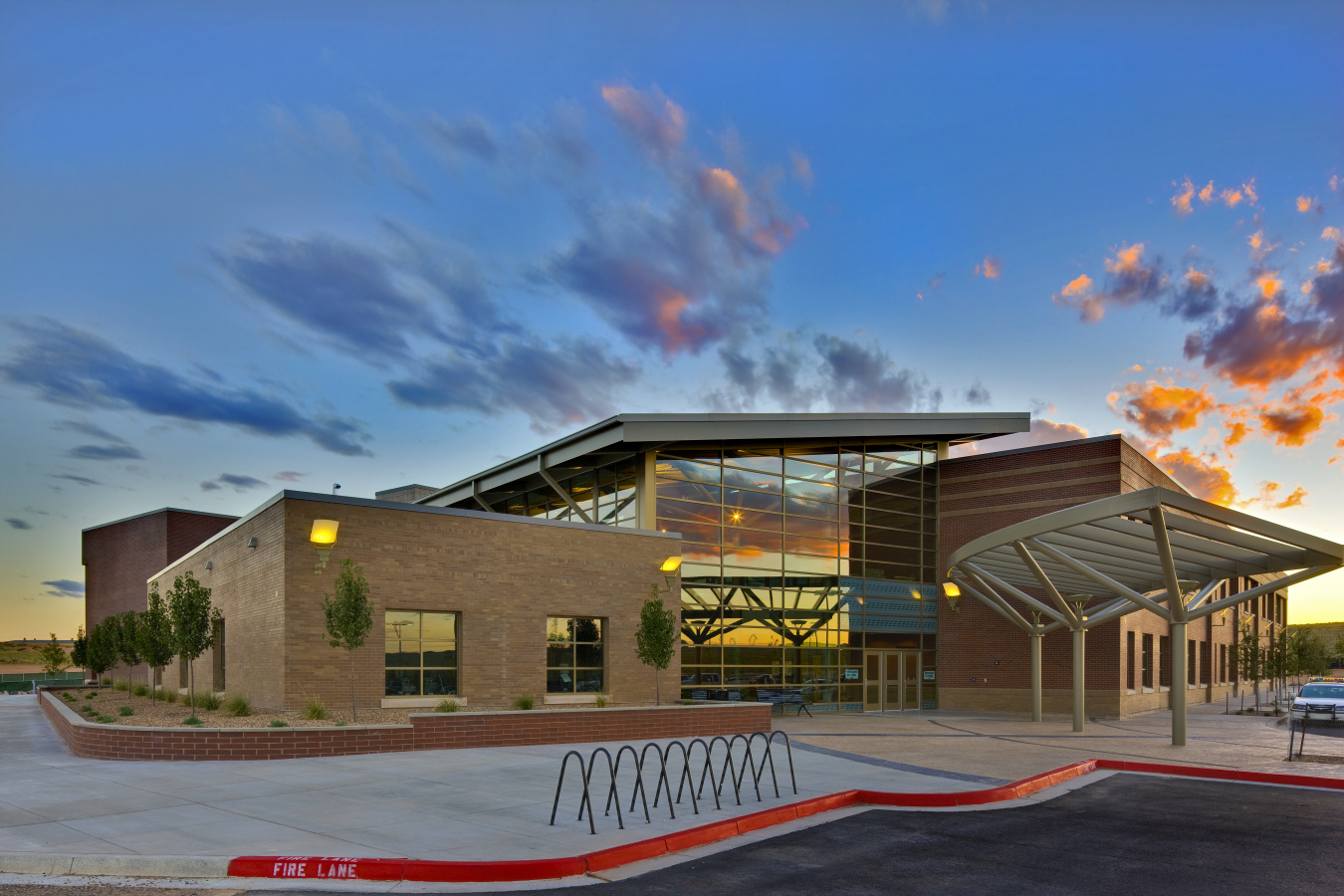 A modern building against a darkening sky.