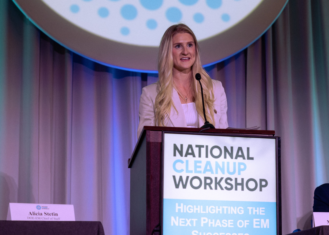A person standing at a podium speaking. 