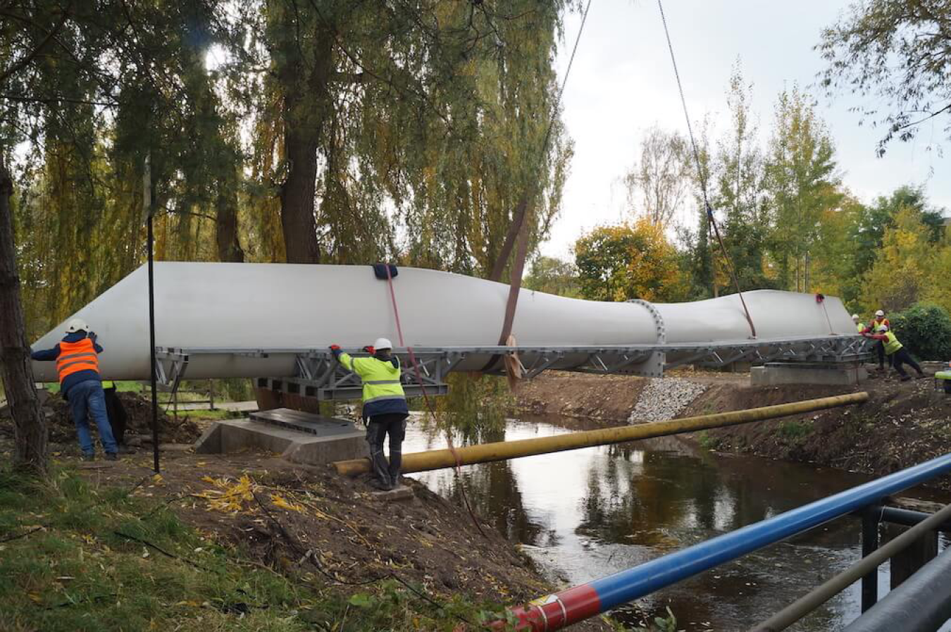Construction workers install a footbridge across the Szprotawa River in Poland.
