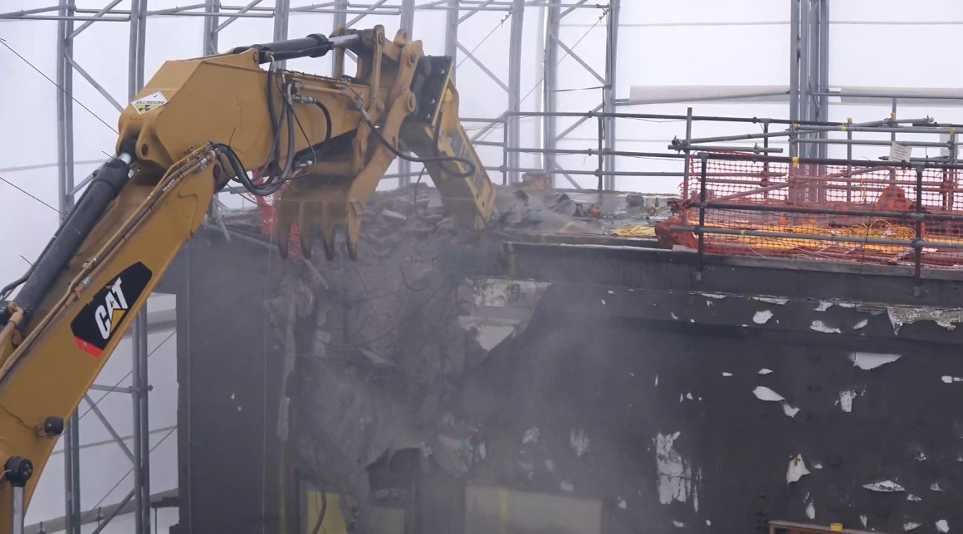 Construction vehicle demolishing a hot cell at the Oak Ridge Site