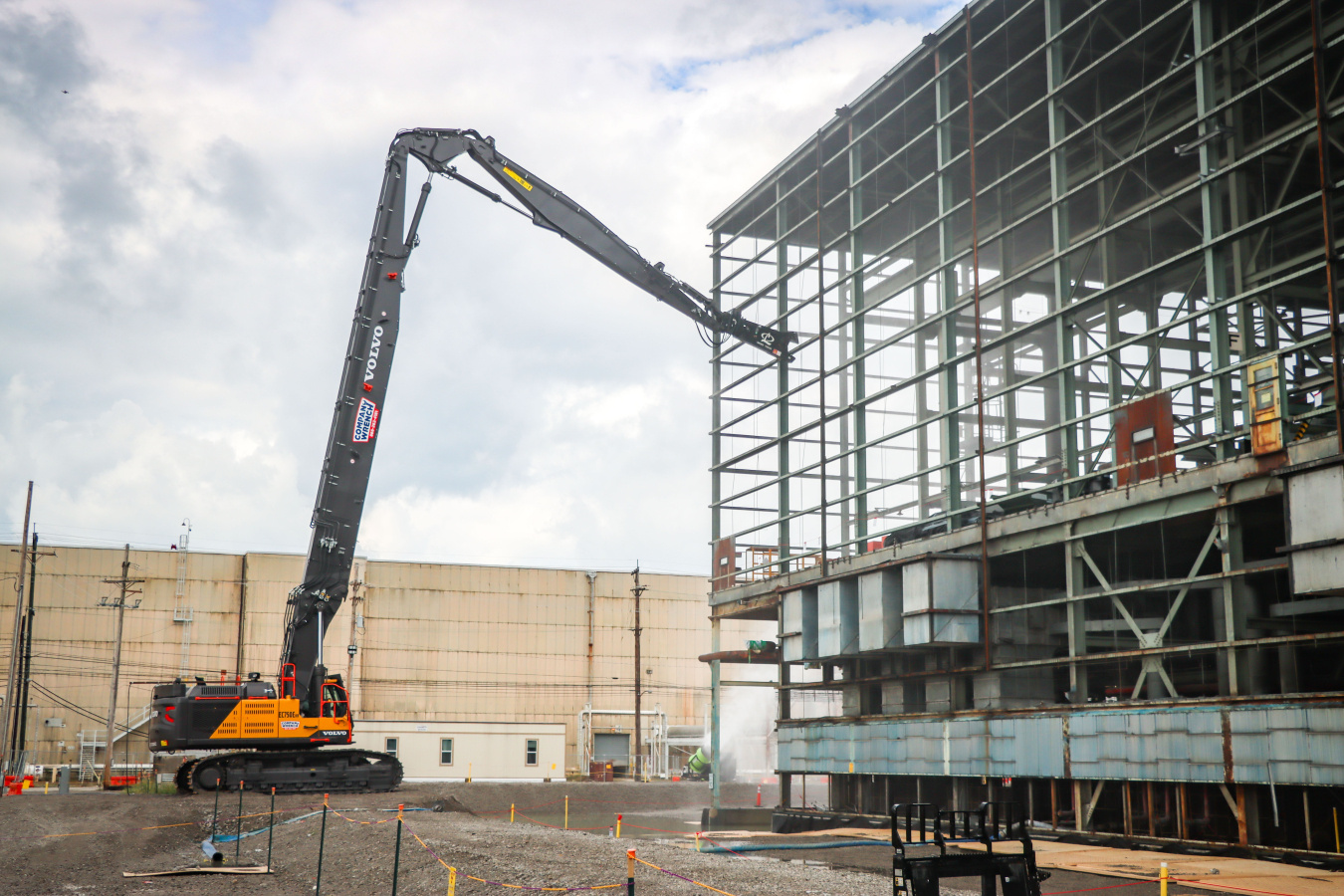 A building being worked on by a construction vehicle