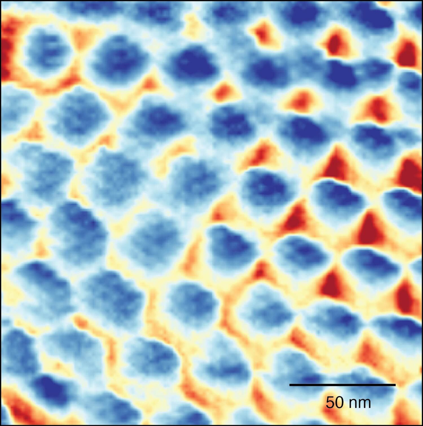 Image of a Wigner crystal captured by a high resolution ultra-low temperature scanning tunneling microscope. The periodic sites (blue) form a triangular structure with each consisting of exactly one electron separated by 40 billionths of a meter.