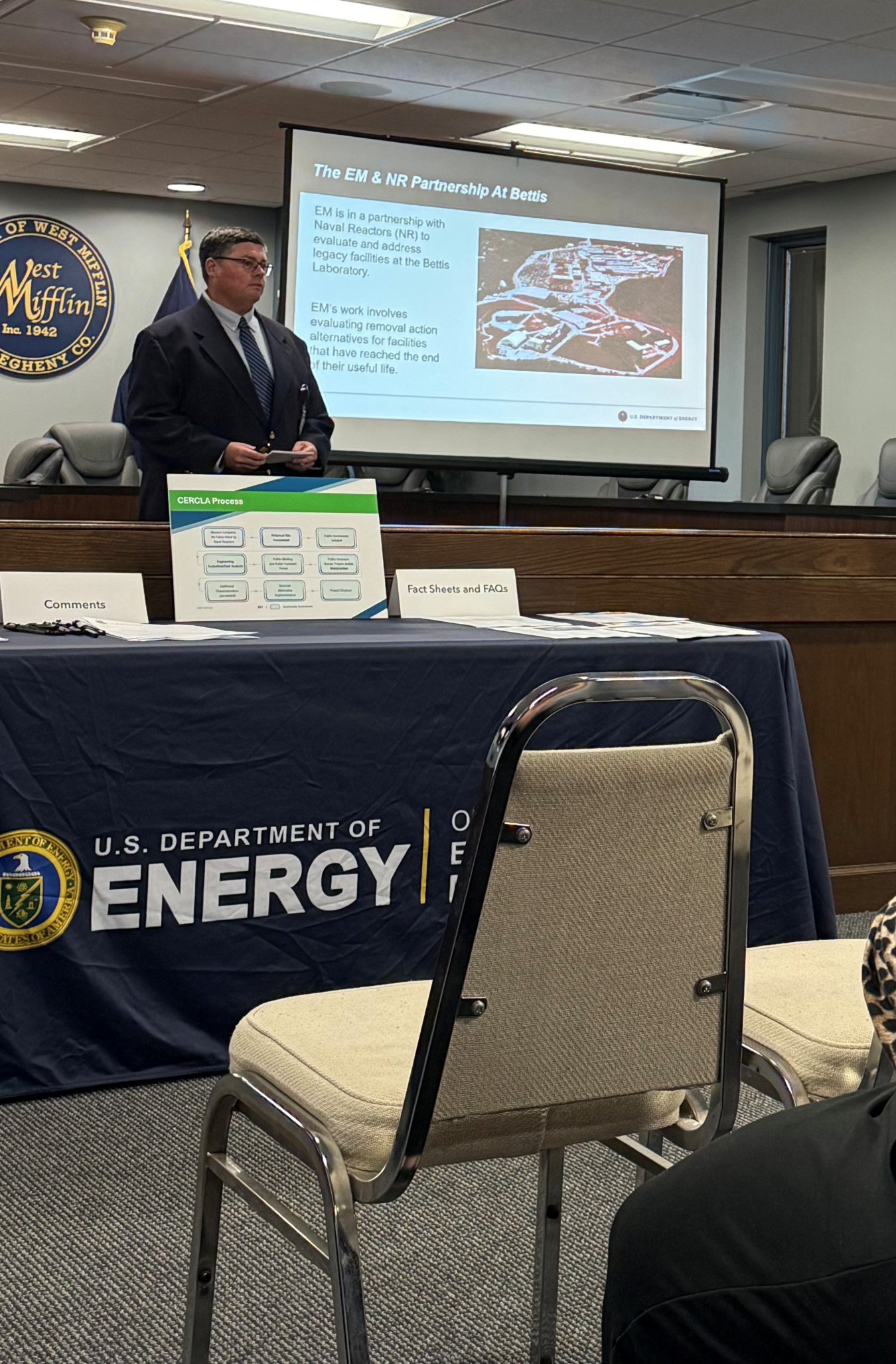 A man giving a presentation at the front of a room