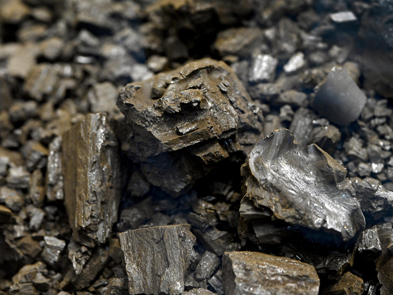 Close-up shot of dark grayish-brown salt crystals for nuclear reactor fuel.