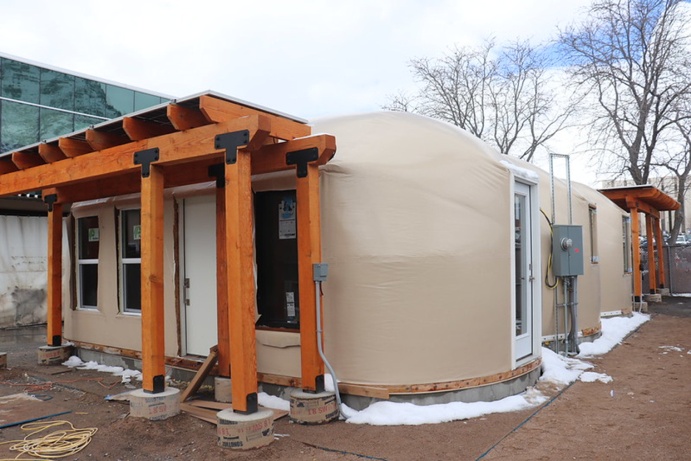 Exterior of a one-level house with the entrance showing in the foreground.