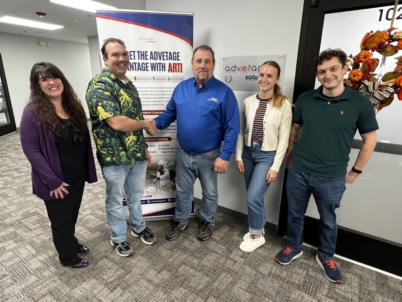 A group of five professionals posing for a picture together 