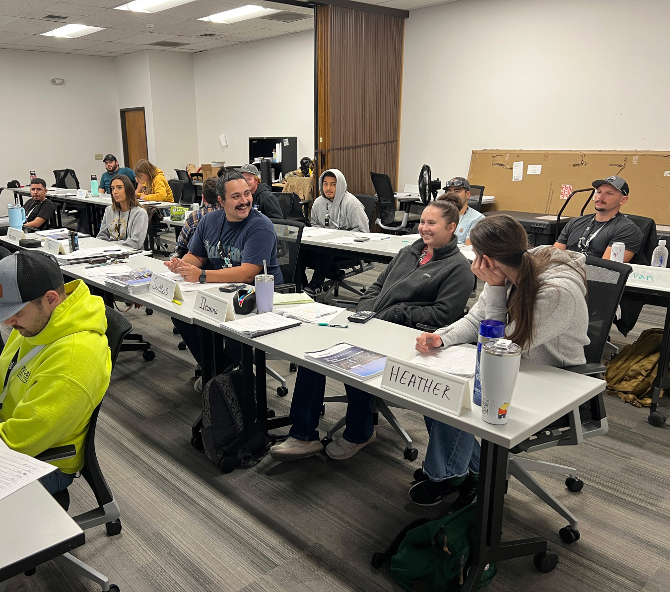 Students in a chemical operator class sitting at three rows of long tables in classroom
