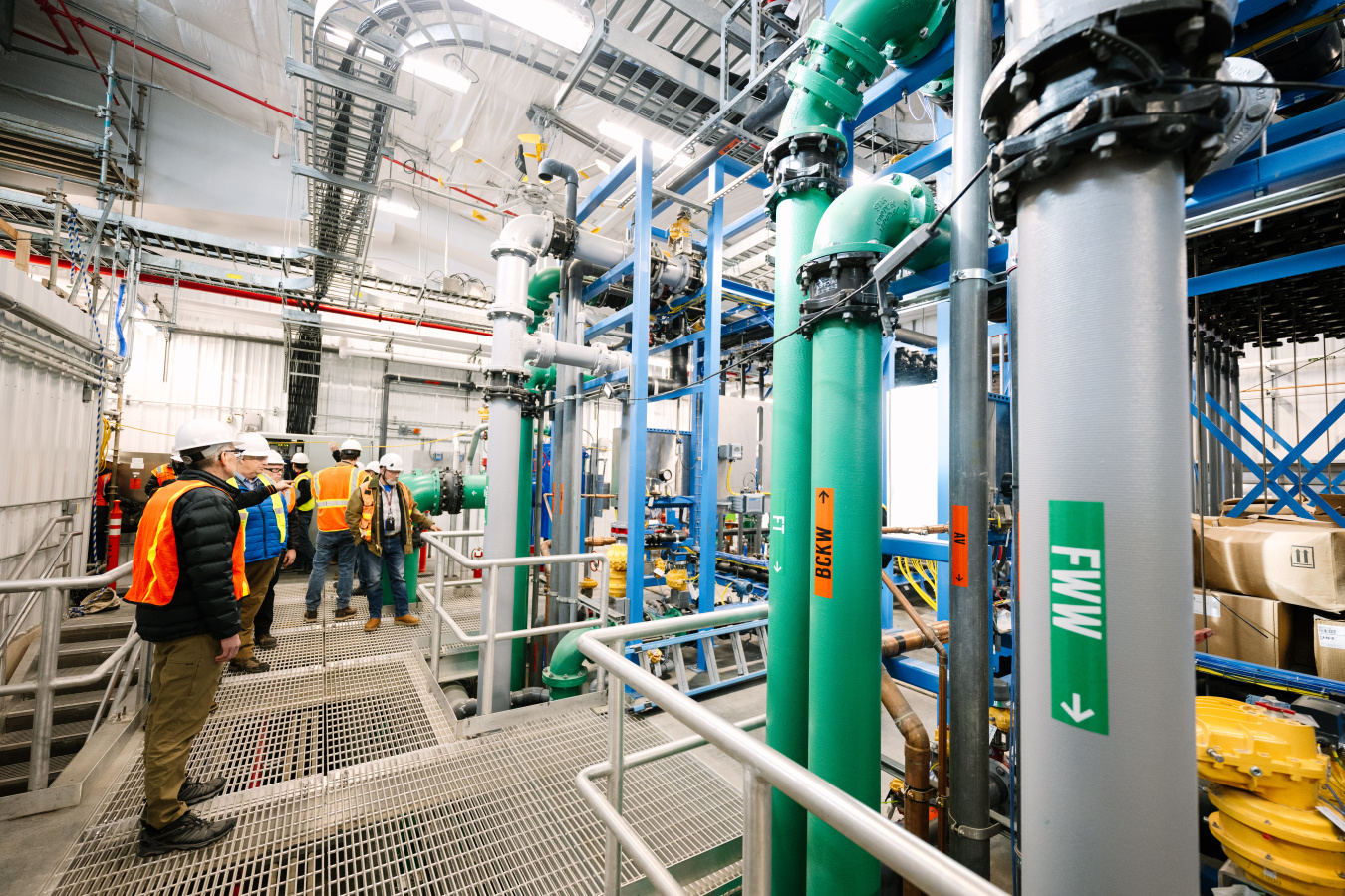 The inside of the water treatment facility with lots of different colored pipes and tools