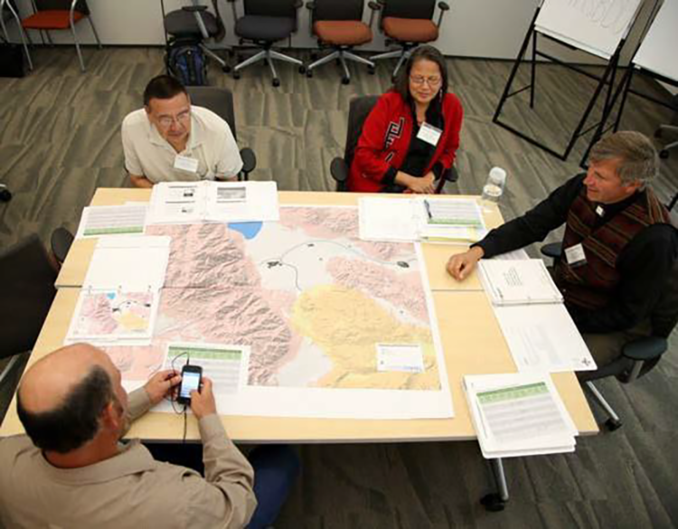 Aerial shot of four workshop attendees at table