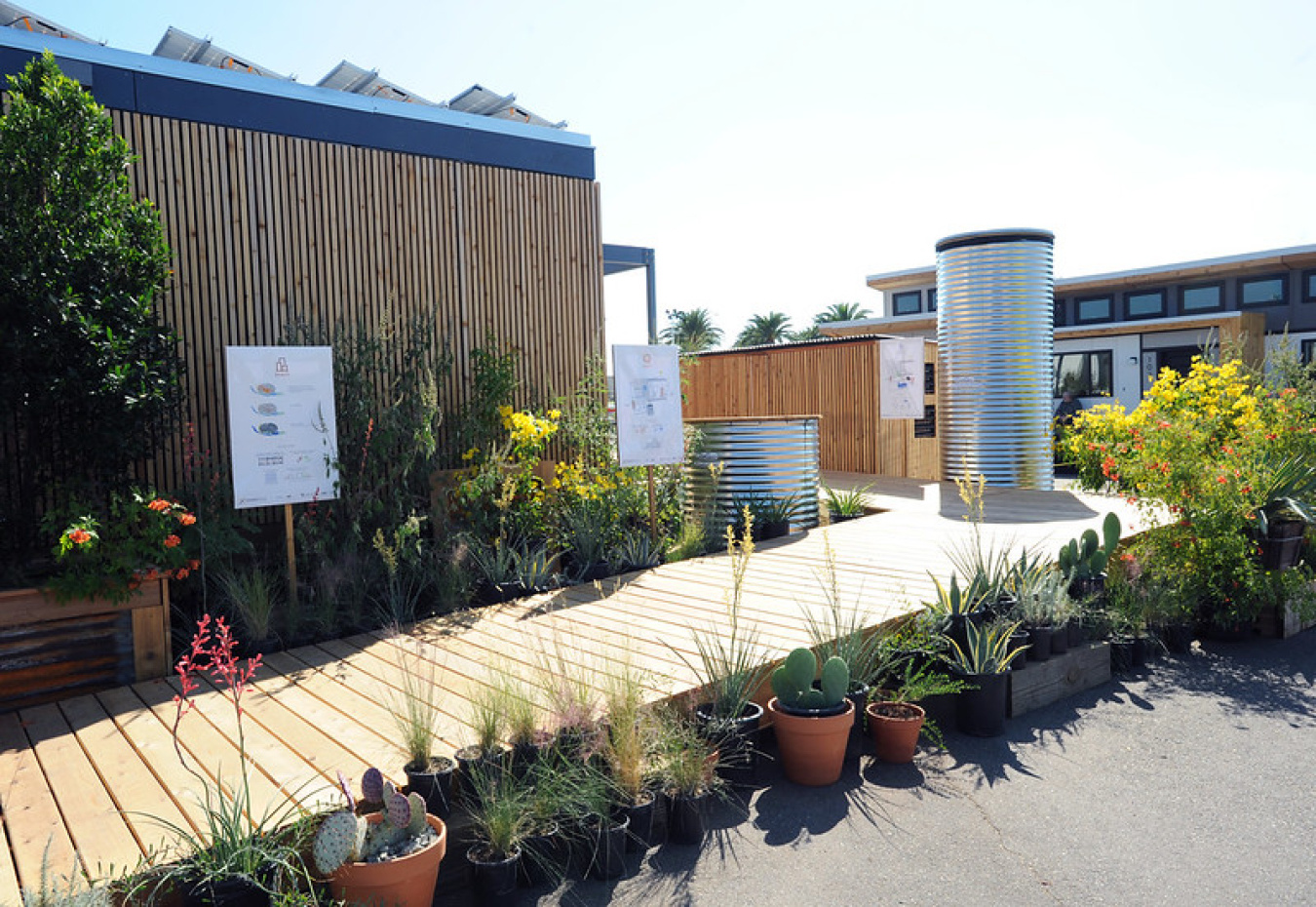 A building with a walkway surrounded by plants