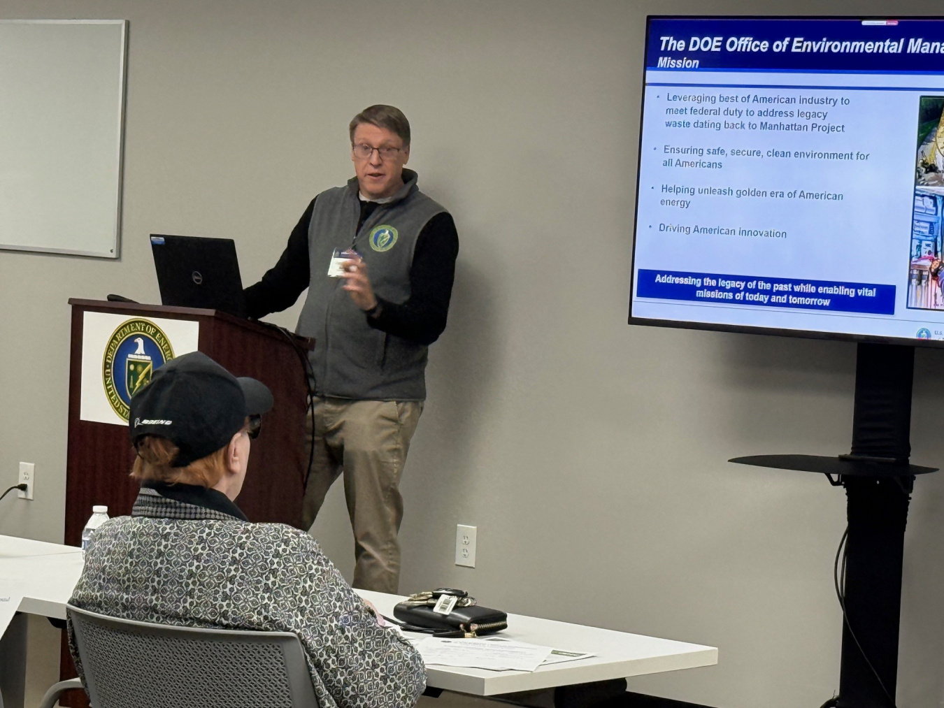 A man giving a presentation at the front of a room