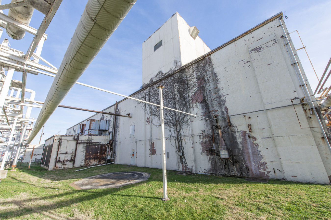A large, old, white steam plant building at the Oak Ridge Site