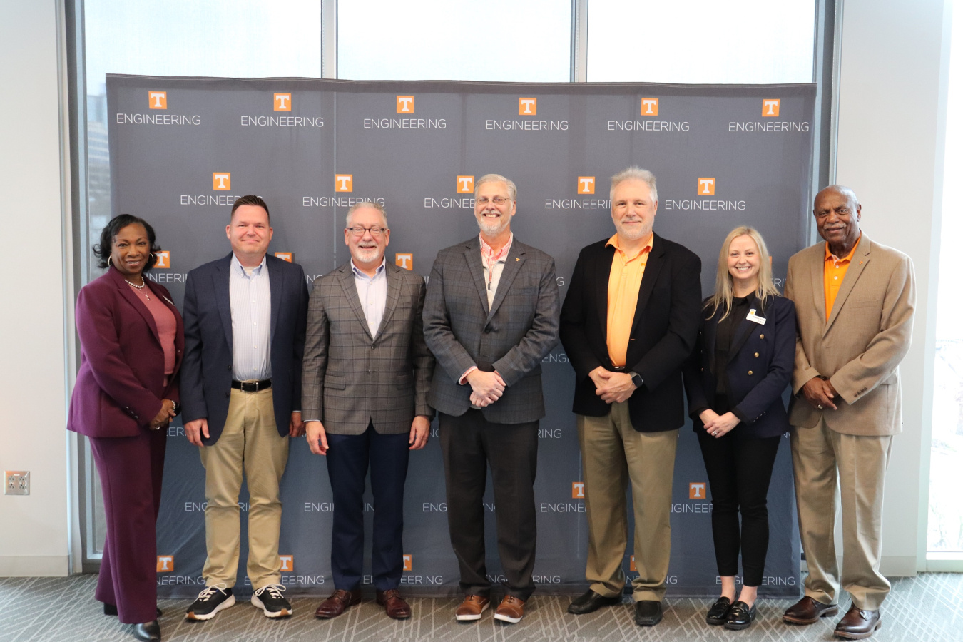 A group of professionals smiling for a group photo