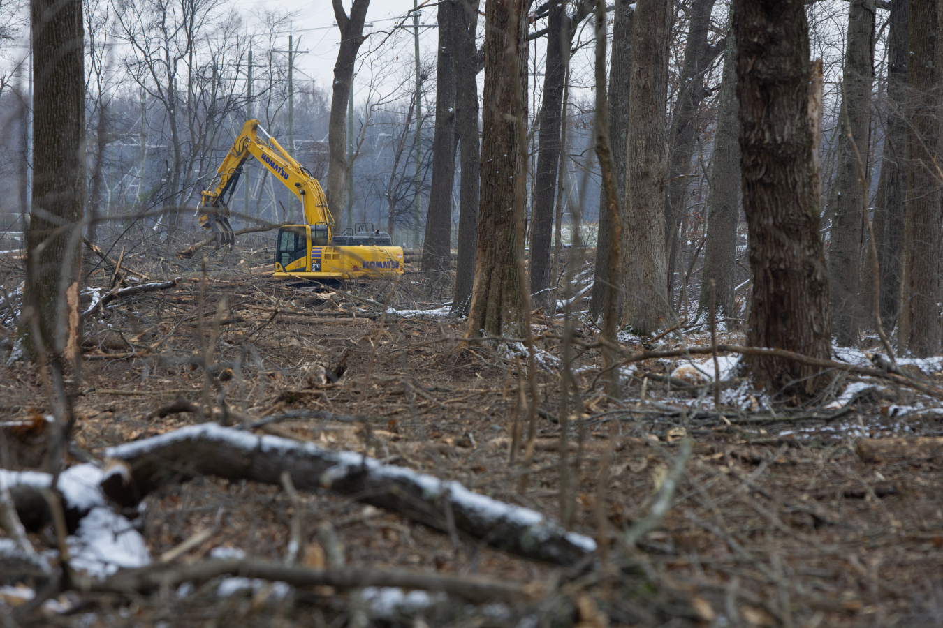 A yellow construction vehicle in the woods at the Paducah Site