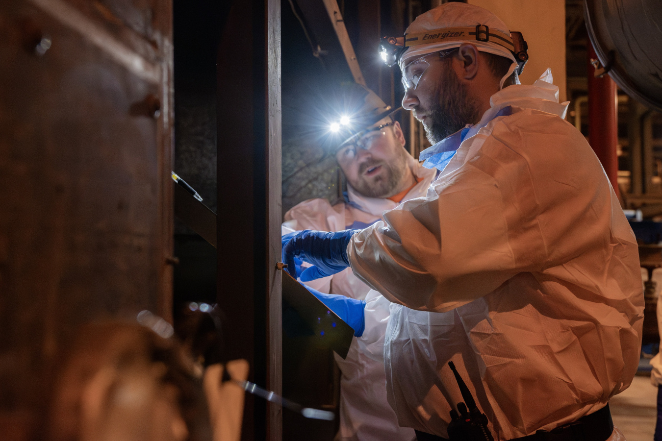 Employees in protective gear working with gas equipment at the Paducah Site