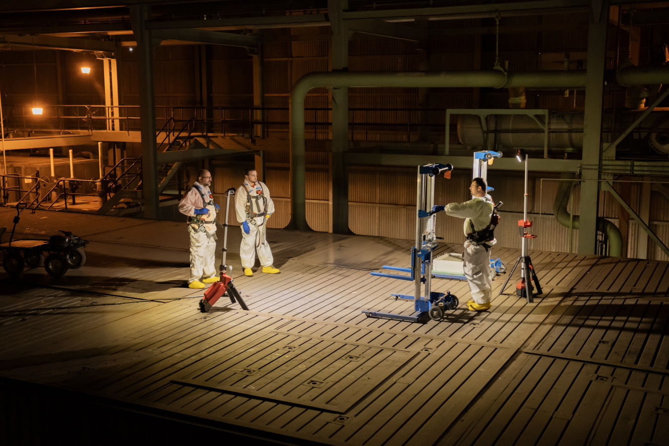 Employees in protective gear using scan technology at the Oak Ridge Site