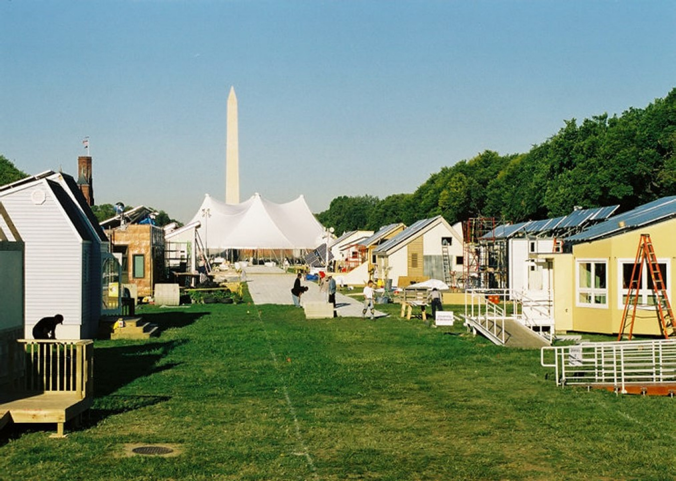 The 2002 Build Challenge event site on the National Mall in Washington, D.C., showing some of the teams' constructed houses and the Washington Monument in the distance.