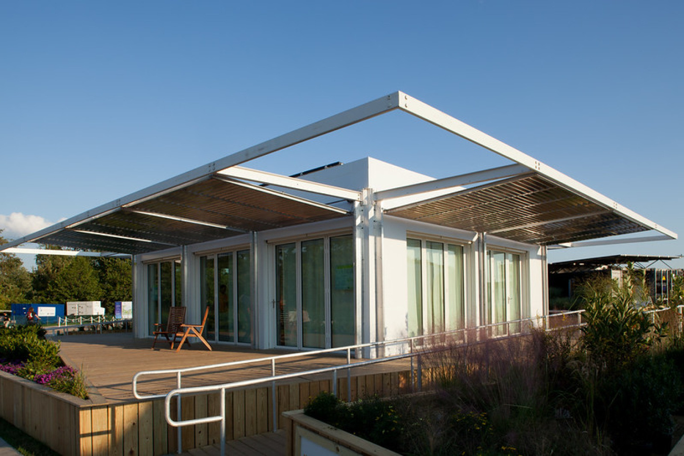 Exterior of the Florida team's Build Challenge house, showing a stylistic roof over a squarish structure with lots of full-length windows, and a porch in front.