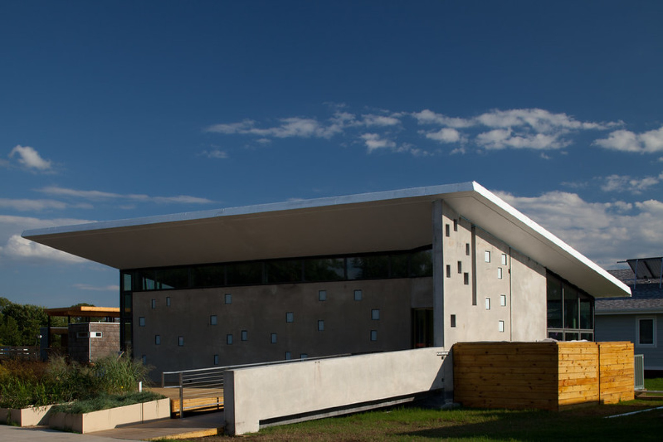 Exterior of Team New Jersey's Build Challenge house, a simple structure with a large flat roof leaving an overhang around it.