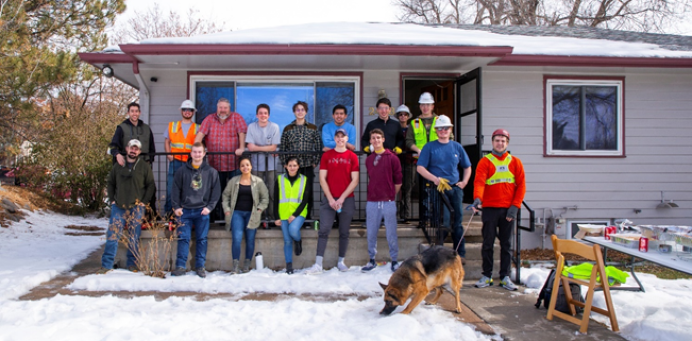 The Denver team members standing in front of their Build Challenge competition house.