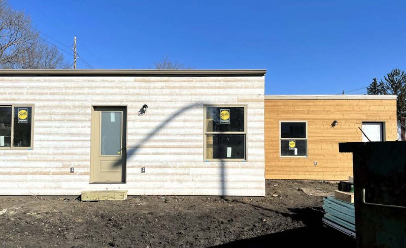 Exterior of the Illinois team's Build Challenge house, showing a large section on the left and a smaller section on the right, with the clear sky overhead.