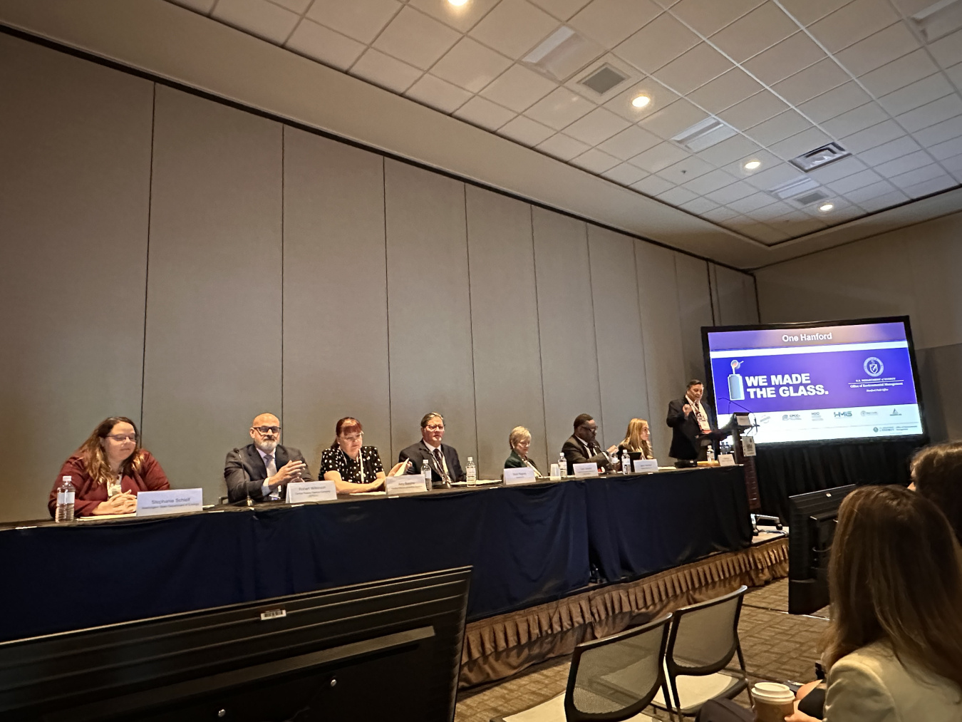 A group of participants on a stage taking part in a panel at a conference