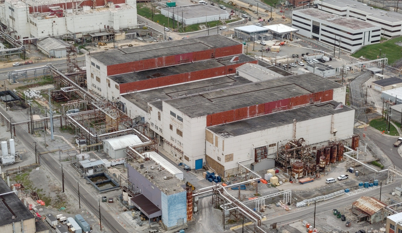 Aerial view of a large white, red, and black building at the Oak Ridge Site